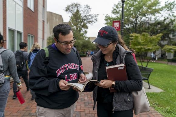 Man and woman looking into book