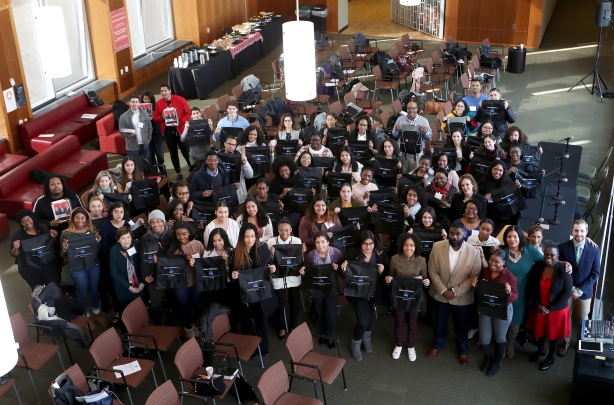  Group of students standing holding bags  