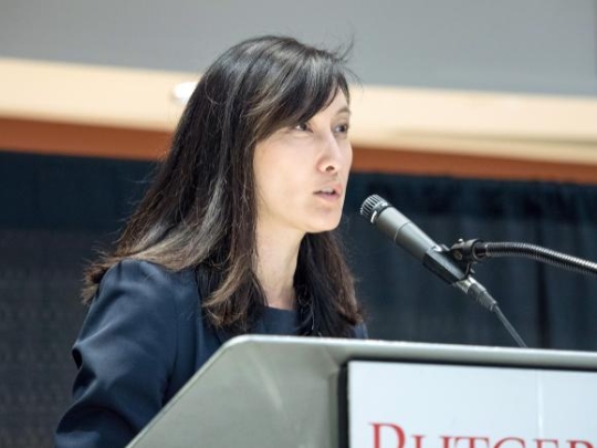 Woman speaking at podium.