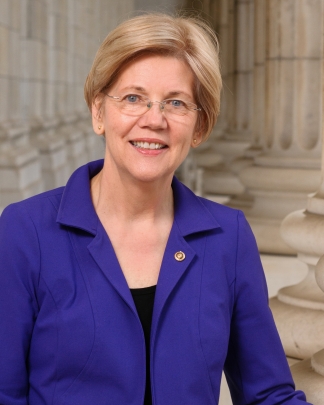 woman in glasses and blue suit smiling